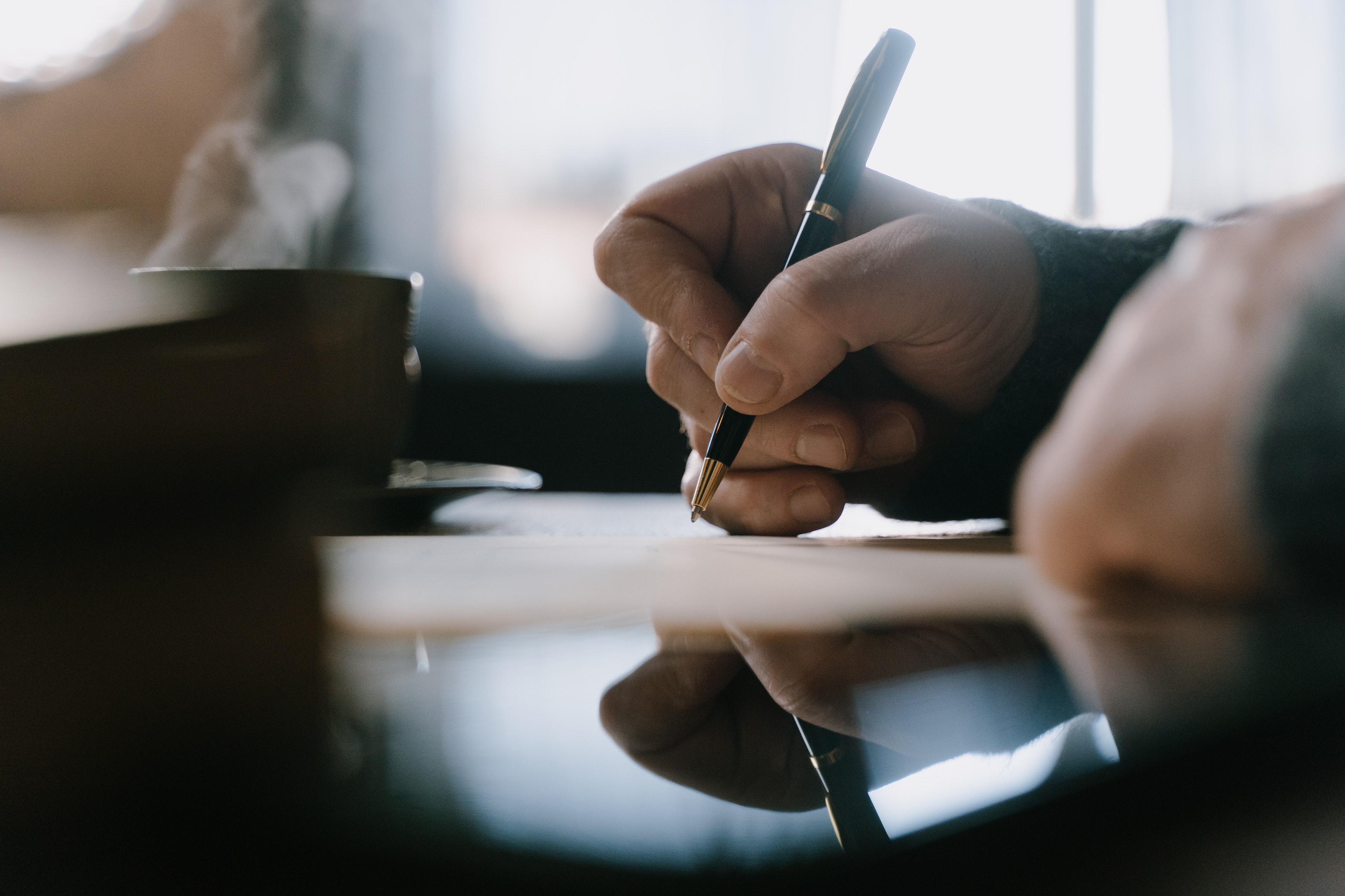 Person writing a letter by hand