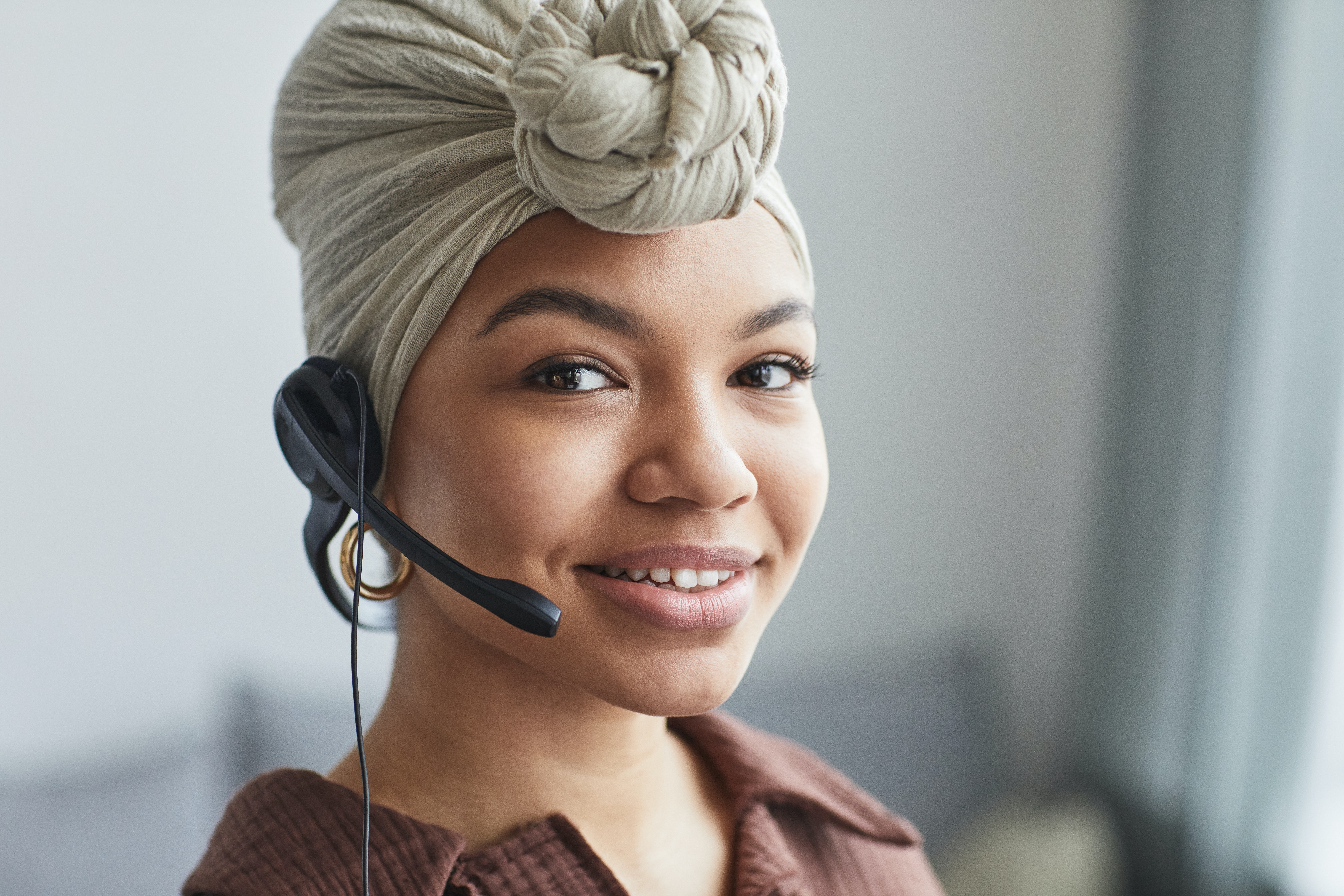 Woman in office talking on telephone headset